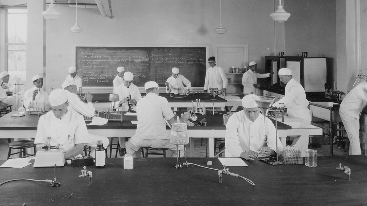 Black and white archival image of bacteriology class from the 1920s