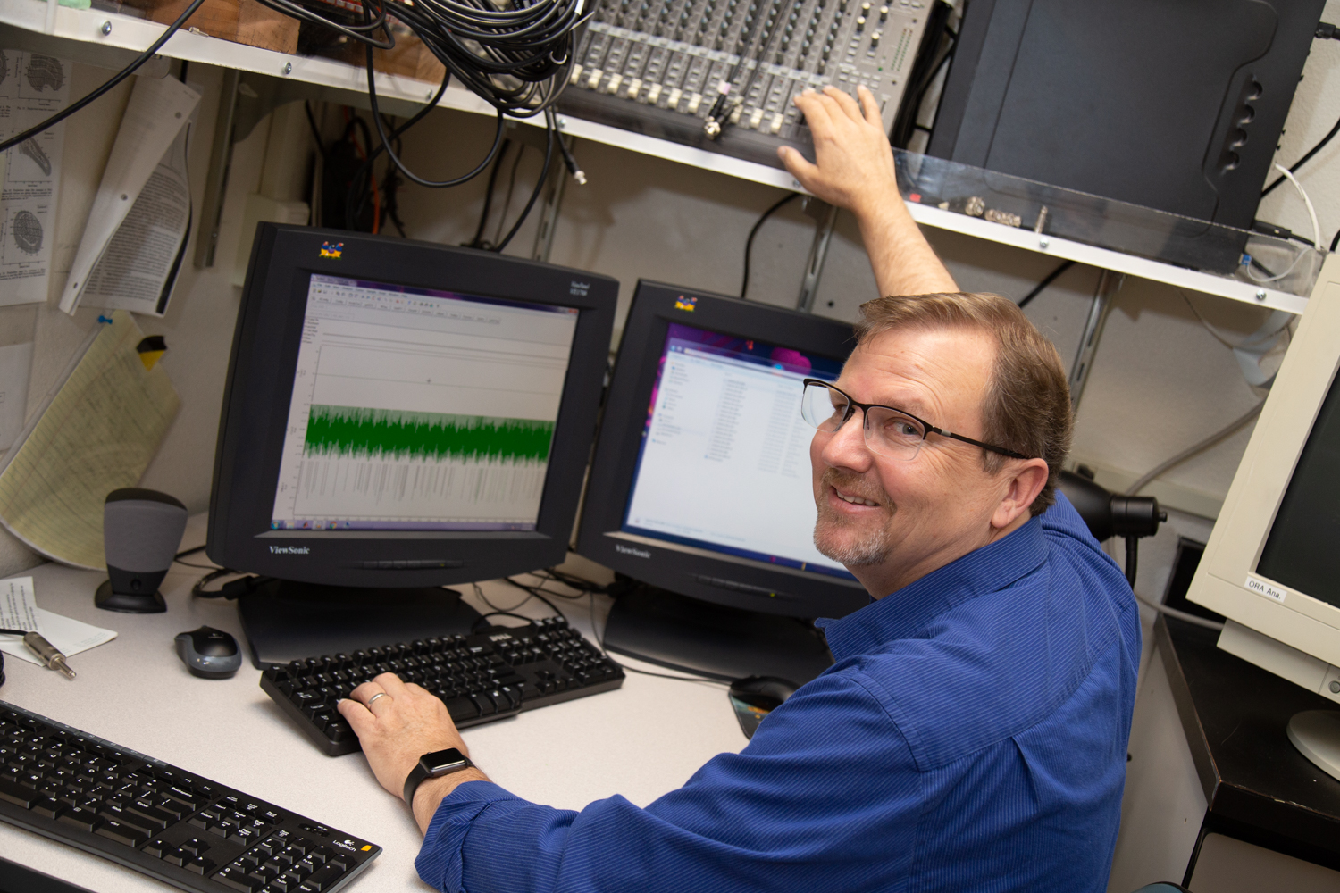 Usrey sits at a desk in his lab