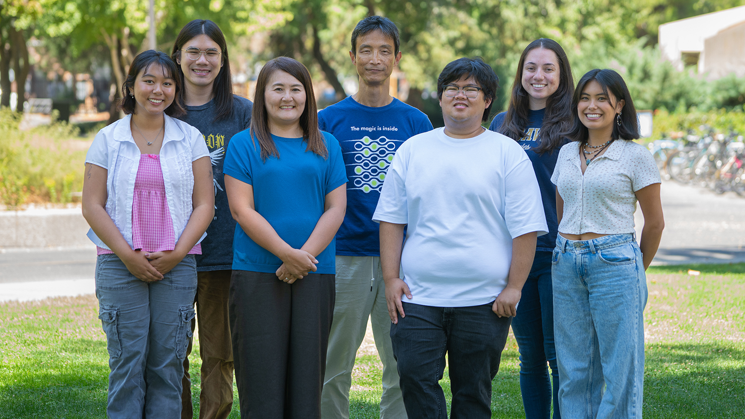 Professor Fumika Hamada stands with her research team outdoors on the UC Davis campus.