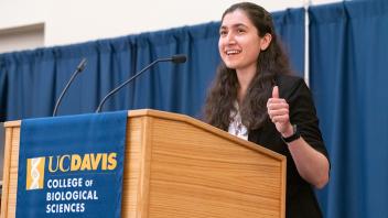 Female student speaking at podium. 