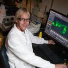 Mark Huising sits at lab bench