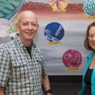 Professors Luca Comai and Michele Igo pose by a BIS 2A classroom mural. David Slipher/UC Davis
