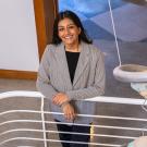 Amrit Bains in stairwell next to DNA helix sculpture