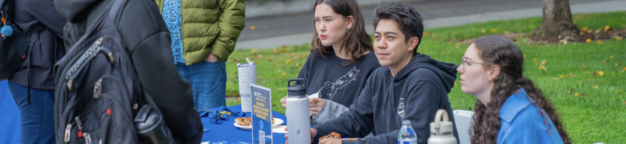 Students and faculty talk at the UC Davis Biophysics Graduate Group table during the Grad Student Fair.